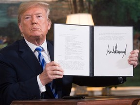 U.S. President Donald Trump signs a document reinstating sanctions against Iran after announcing America's withdrawal from the Iran nuclear deal, on May 8, 2018.
