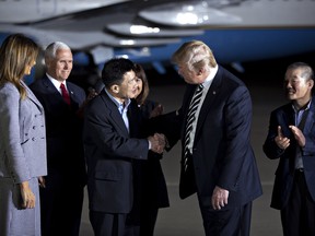 U.S. President Donald Trump, second right, shakes hands with Kim Sang Dok, also known as Tony Kim, an American citizen released from detention in North Korea, as U.S. First Lady Melania Trump, left, U.S. Vice President Mike Pence, second left, and Kim Dong Chu, right, look on at Joint Base Andrews, Maryland, U.S., on Thursday, May 10, 2018.