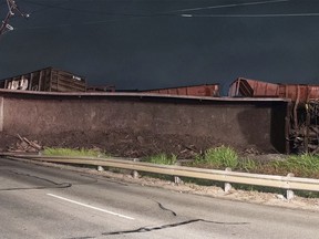 A train is derailed in Fort Worth, Texas, Wednesday, May 2, 2018. The derailment knocked out power and closed a major artery for rush-hour traffic. About 40 train cars were traveling north of downtown early Wednesday when the derailment occurred, causing about 25 cars to slide off the tracks. The cause of the derailment isn't known and it is not clear which rail company was operating the train.