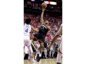 Houston Rockets guard Chris Paul shoots over Golden State Warriors guard Quinn Cook during the second half in Game 5 of the NBA basketball playoffs Western Conference finals in Houston, Thursday, May 24, 2018. Paul was hurt on the play.