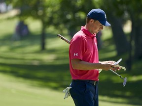 Jordan Spieth looks over his notes during the third round of the Fort Worth Invitational golf tournament at Colonial Country Club in Fort Worth, Texas, Saturday, May 26, 2018.