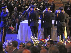 Colleagues salute their fallen comrade at the funeral for Dallas Police Officer Officer Rogelio Santander at Lake Pointe Church in Rockwall, Texas on Tuesday, May 1, 2018. Santander was shot and killed at a Home depot in Dallas last week.