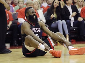 Houston Rockets guard James Harden reacts after he was injured during the first half of Game 1 of the NBA basketball Western Conference Finals against the Golden State Warriors, Monday, May 14, 2018, in Houston.