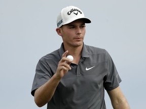 Aaron Wise acknowledges applause from the gallery after sinking a putt for birdie on the fifth green during the final round of the AT&T Byron Nelson golf tournament in Dallas, Sunday, May 20, 2018.