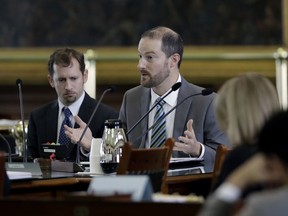 In this Feb. 26, 2018, photo, David J. Hacker, special counsel for litigation for the Texas attorney general's office, right, and Brantley Starr, deputy first attorney general, left, take part in a committee meeting on religious freedom laws at the Texas Capitol, in Austin, Texas. Lawyers who espouse a conservative Christian agenda have been growing in influence since the Trump administration took office.