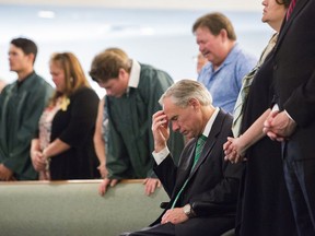 The Texas Gov. Greg Abbott joins a congregation in prayer on Sunday, May 20, 2018, at the Arcadia First Baptist Church, after a school shooting at Santa Fe High School on Friday, in Santa Fe, Texas.
