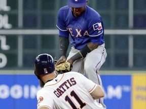 Houston Astros designated hitter Evan Gattis (11) is safe at second on a steal as Texas Rangers shortstop Jurickson Profar tries to make the tag during the third inning of a baseball game Saturday, May 12, 2018, in Houston.