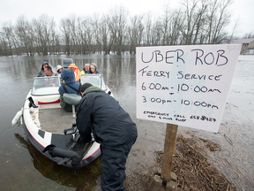 Rob Dekany, known locally as Uber Rob, ferries stranded passengers at Darlings Island, N.B. on Thursday, May 3, 2018 as the Kennebecasis River flooded the only road into the community.