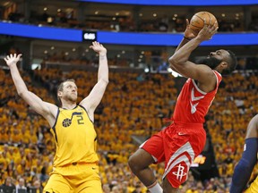 Houston Rockets guard James Harden, right, shoots as Utah Jazz forward Joe Ingles (2) defends during the first half in Game 4 of an NBA basketball second-round playoff series Sunday, May 6, 2018, in Salt Lake City.