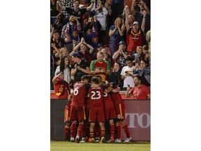 Real Salt Lake players celebrate a goal by midfielder Kyle Beckerman (5) against the Houston Dynamo during an MLS soccer match Wednesday, May 30, 2018, in Sandy, Utah.