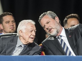 Former president Jimmy Carter talks with Liberty University president Jerry Falwell Jr. during the 45th commencement ceremony at Liberty on Saturday May 19, 2018, in Lynchburg, Va.