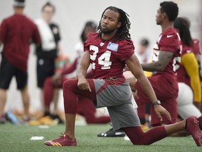 Washington Redskins defensive back Josh Norman (24) stretches during an NFL football team practice, Wednesday, May 23, 2018, in Ashburn, Va.