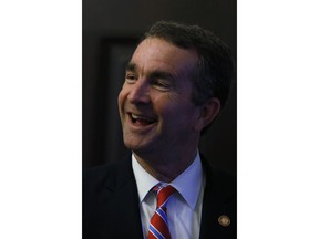 Virginia Gov. Ralph Northam reacts to the House and Senate passing the new state budget with Medicaid expansion as one of the provisions, as he met with cabinet members and staff at the State Capitol n Richmond, Va., Wednesday, May 30, 2018.