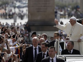 Pope Francis waves to faithful as he arrives for his weekly general audience in St. Peter's Square, at the Vatican, Wednesday, May 30, 2018.