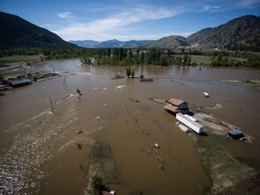 A home damaged by flood waters is seen in an aerial view, near the Kettle River in Grand Forks, B.C., on Saturday May 12, 2018. Thousands of people have been evacuated from their homes in British Columbia's southern interior as officials warn of flooding due to extremely heavy snowpacks, sudden downpours and unseasonably warm temperatures.