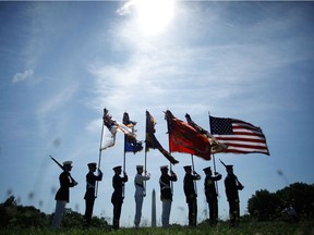 A U.S. military color guard prepares to march into a ceremony commemorating the 50th anniversary of the first two American combat casualties of the Vitenam War at The Wall  on the National Mall July 8, 2009 in Washington, DC. Percy Ronald Chess is said to have served during the last years of the Vietnam war, although reports say he never left the U.S.