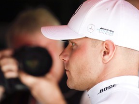 Mercedes driver Valtteri Bottas of Finland, right, waits in the paddock during free practice at the Barcelona Catalunya racetrack in Montmelo, just outside Barcelona, Spain, Friday, May 11, 2018. The Formula One race will take place on Sunday.