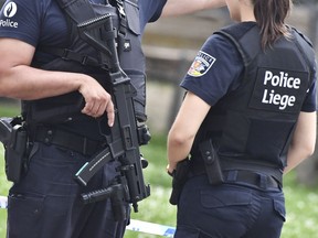 Belgian police guard the scene of a shooting in Liege, Belgium, Tuesday, May 29, 2018. A gunman killed three people, including two police officers, in the Belgian city of Liege on Tuesday, a city official said. Police later killed the attacker, and other officers were wounded in the shooting.