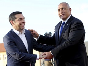 Greek Prime Minister Alexis Tsipras, left, is greeted by Bulgarian Prime Minister Boyko Borissov as he arrives for a dinner with EU and Western Balkan heads of state at the Sofia Tech Park in Sofia, Bulgaria, Wednesday, May 16, 2018.