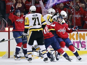 Washington Capitals center Lars Eller, left, from Denmark, and Washington Capitals left wing Jakub Vrana, right, from the Czech Republic, celebrate a goal by right wing Brett Connolly during the first period of Game 5 in the second round of the NHL Stanley Cup hockey playoffs against the Pittsburgh Penguins, Saturday, May 5, 2018, in Washington.
