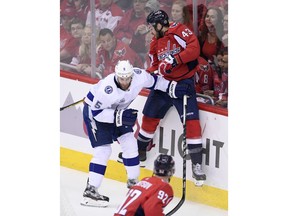 Washington Capitals right wing Tom Wilson (43) hits the boards next to Tampa Bay Lightning defenseman Dan Girardi (5) during the first period of Game 4 of the NHL hockey Eastern Conference finals Thursday, May 17, 2018 in Washington.
