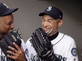 Seattle Mariners' Ichiro Suzuki, right, and Robinson Cano laugh before the team's baseball game against the Oakland Athletics on Wednesday, May 2, 2018, in Seattle.