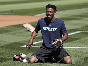 Seattle Mariners center fielder Dee Gordon smiles as he goes through a drill before the team's baseball game against the Texas Rangers Tuesday, May 15, 2018, in Seattle. Gordon could fill in at second base while Robinson Cano is out for 80 games on suspension for violating baseball's joint drug agreement.