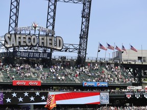 In honor of Memorial Day weekend, United States flags are flown Instead of the usual ones representing MLB teams on the small flagpoles at right at Safeco Field in Seattle during a baseball game between the Seattle Mariners and the Minnesota Twins, Sunday, May 27, 2018.