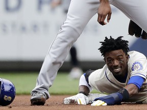 Seattle Mariners' Dee Gordon reacts below Detroit Tigers second baseman Niko Goodrum after losing his helmet on a slide as he was forced at second during the first inning of a baseball game, Sunday, May 20, 2018, in Seattle.