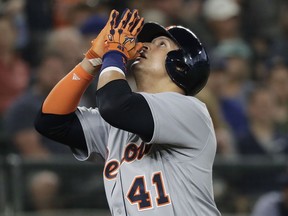 Detroit Tigers' Victor Martinez gestures as he scores on a solo home run against the Seattle Mariners during the second inning of a baseball game Saturday, May 19, 2018, in Seattle.