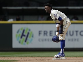 Seattle Mariners' Dee Gordon stands on second base after stealing in the 11th inning of a baseball game against the Detroit Tigers, Sunday, May 20, 2018, in Seattle. Gordon scored from second on a walk-off RBI single hit by Jean Segura and the Mariners won 3-2 in 11 innings.