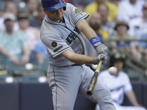 New York Mets' Devin Mesoraco hits a run-scoring single against the Milwaukee Brewers during the first inning of a baseball game Saturday, May 26, 2018, in Milwaukee.