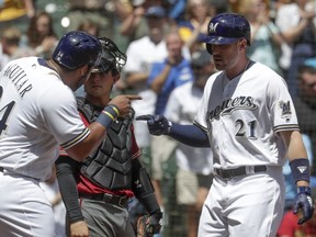 Milwaukee Brewers' Jesus Aguilar congratulates Travis Shaw (21) after his three-run home run during the fourth inning of a baseball game against the Arizona Diamondbacks Wednesday, May 23, 2018, in Milwaukee.