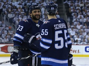 Winnipeg Jets defenceman Dustin Byfuglien (left) and centre Mark Scheifele have a discussion in the Nashville Predators zone prior to a face-off during Game 6 of their second-round playoff series on May 7.