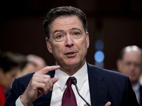 FILE - In this June 8, 2017 file photo, former FBI director James Comey speaks during a Senate Intelligence Committee hearing on Capitol Hill in Washington. Rudy Giuliani, Trump's new attorney, says Trump fired Comey last year "because Comey would not, among other things, say that he wasn't a target" of the special counsel's Russia investigation.