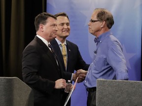 In this April 30, 2018, photo, Senate candidates from left, Todd Rokita, Luke Messer and Mike Braun speak with each other following the Indiana Republican senate primary debate in Indianapolis. As primary season kicks into high gear, Republicans are engaged in nomination fights that are pulling the party to the right, leaving some leaders worried their candidates will be out of a step with the broader electorate in the November election.