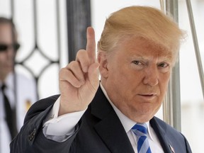 In this May 4, 2018 photo, President Donald Trump signals to the press that he will come over to talk, as he leaves the White House for Dallas to address the National Rifle Association in Washington.  Trump is striking a combative tone against the Russia probe. He's talking about "Fighting Back" and telling Democrats on the special counsel's team, "wait 'till the Courts get to see your unrevealed Conflicts of Interest!" Trump tweeted Monday about Robert Mueller's investigation into possible collusion between the Trump campaign and Russia.