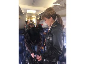 This photo provided by Diana McBride Self shows Flight 1380 pilot Tammie Jo Shults, right, interacting with passengers after emergency landing the plane, Tuesday, April 17, 2018. Passengers praised Shults for her professionalism during the emergency. Shults, one of the first female fighter pilots in the Navy, was at the controls when the jet landed, according to her husband, Dean Shults. She got a round of applause from the passengers after putting the plane down safely. She walked through the aisle and talked with passengers to make sure they were OK afterward.
