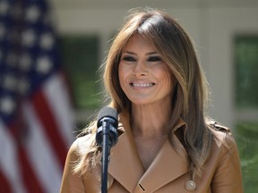 In this May 7, 2018 photo, First lady Melania Trump speaks on her initiatives during an event in the Rose Garden of the White House in Washington.  The White House says Melania Trump is hospitalized after undergoing a procedure to treat a benign kidney condition.