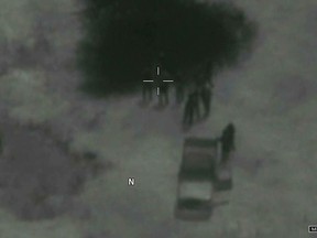 In this image from video released by the Department of Defense, Niger military members arrive at the scene where the body of Army Sgt. La David T. Johnson, 25, of Miami Gardens, Fla., was recovered after an ambush that killed four U.S. service members in October 2017 in Niger. The dramatic new drone video, released May 17, 2018, of the ambush that killed four American soldiers shows U.S. forces desperately trying to escape, and fighting for their lives after friendly Nigerien forces mistook them for the enemy. (Department of Defense via AP