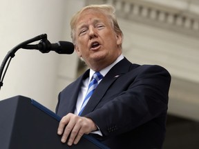 In this May 28, 2018, photo, President Donald Trump speaks during a Memorial Day ceremony at Arlington National Cemetery in Arlington, Va. Trump on Tuesday seized on an error by liberal activists who tweeted photos of young-looking immigrants at the U.S.-Mexico border in steel cages and blamed the current administration for separating immigrant children from their parents. The photos were taken by The Associated Press in 2014, when President Barack Obama was in office. The photo captions reference children who crossed the border as unaccompanied minors.
