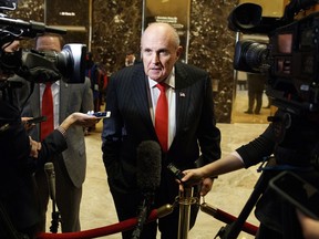 FILE - In this Jan. 12, 2017, file photo, former New York City Mayor Rudy Giuliani talks with reporters in the lobby of Trump Tower in New York. Once known as "America's Mayor" and hailed for helping unite a wounded city, Giuliani has become the face of President Donald Trump's aggressive new legal team.