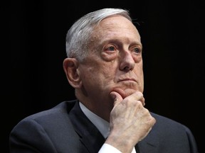 FILE - In this April 26, 2018, file photo, Defense Secretary Jim Mattis listens to a question during a hearing on Capitol Hill in Washington. Mattis says the U.S. will continue to confront China's militarization of manmade islands in the South China Sea, arguing that Beijing hasn't abided by its promise not to put weapons on the Spratly Islands.