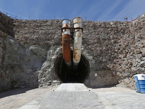 FILE - This April 9, 2015, file photo shows the south portal of the proposed Yucca Mountain nuclear waste dump near Mercury, Nev.  The House is moving to approve an election-year bill to revive the mothballed nuclear waste dump at Nevada's Yucca Mountain despite opposition from home-state lawmakers.