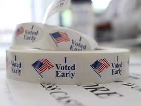 In this May 21, 2018, photo, a roll of stickers awaiting distribution to early voters sits on a table at the check-in station at the Pulaski County Courthouse Annex in Little Rock, Ark. Voters in four states are casting ballots Tuesday as the 2018 midterm elections take shape. Primaries are set in Arkansas, Georgia and Kentucky while voters in Texas settle several primary runoffs from their first round of voting in March.