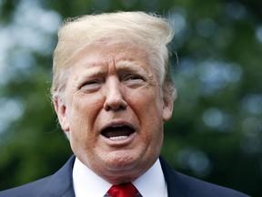 In this May 23, 2018, photo, President Donald Trump speaks to the media before boarding the Marine One helicopter on the South Lawn of the White House in Washington. Two House lawmakers who are allies of President Donald Trump are set to meet with top intelligence officials Thursday as Trump has raised new suspicions about the federal investigation that is looking into his campaign.