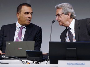Tim Vice President Franco Bernabe', right, talks with Tim CEO Amos Genish prior to the start of the shareholders meeting, in Rozzano, near Milan, Italy, Friday, May 4, 2018.  Telecom Italia shareholders are to decide whether the activist hedge fund Elliott Management has the power to revamp the board against the controlling stakeholder, French entertainment group Vivendi.
