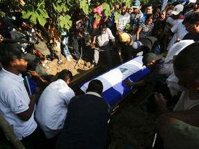 Family members and friends bury Kevin Davila, who died from gunshot wounds he received during protests against the government of President Daniel Ortega, in Managua, Nicaragua, Monday, May 7, 2018. Davila was wounded 17 ago, during several days of street clashes across Nicaragua where dozens of young people were killed. The non-governmental Permanent Commission on Human Rights put the death toll at 63. Other rights groups have documented lower totals.