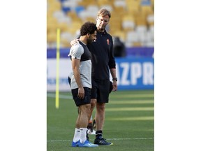 Liverpool coach Juergen Klopp puts his arm around the shoulder of Liverpool's Mohamed Salah during a training session at the Olimpiyskiy Stadium in Kiev, Ukraine, Friday, May 25, 2018 ahead of the Champions League final soccer match between Real Madrid and Liverpool on Saturday May 26.