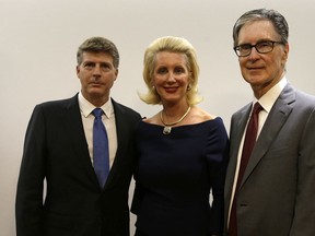 Hal Steinbrenner, left, and Jennifer Steinbrenner Swindal joint owners of the New York Yankees and John Henry owner of the Boston Red Sox pose for a photograph following a press conference in London, Tuesday, May 8, 2018, to announce a two-game series to be played in London. The Boston Red Sox and the New York Yankees will play a MLB two-game series at the London Stadium in London, June 29-30, 2019.